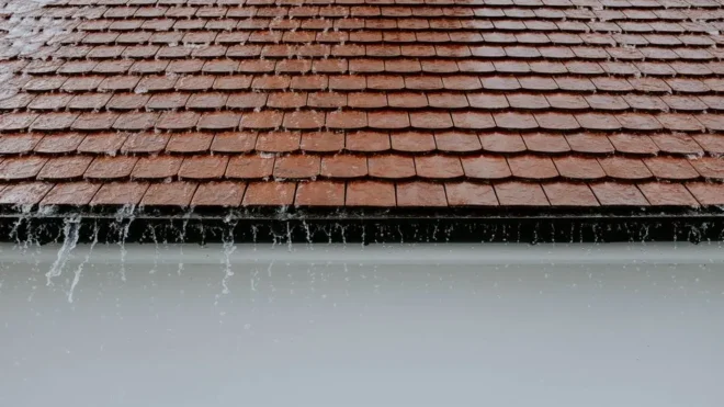 Why do clogged gutters lead to roof leaks?